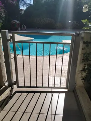 a view of a swimming pool through a gate at Regina by the Sea in Limassol
