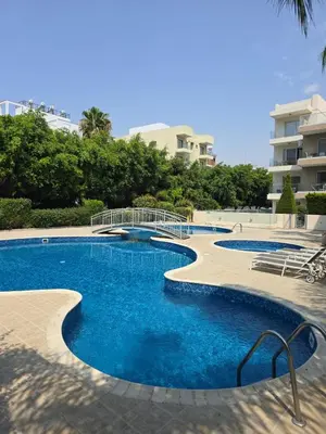 a swimming pool with blue water in a resort at Regina by the Sea in Limassol