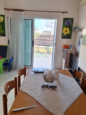 a dining room table with a table cloth and glasses on it at ισόγειο διαμέρισμα με αυλή στην περιοχή Κάππαρη κατάλληλο για οικογενεια in Paralimni