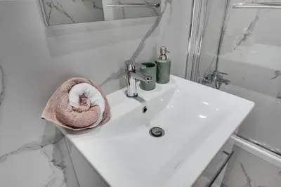 a bathroom with a sink with a towel at Carisa Elysium Larnaca in Larnaka