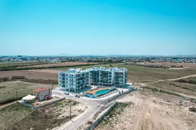 an aerial view of a blue apartment building at Carisa Elysium Larnaca in Larnaka
