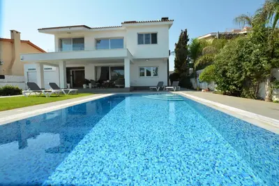 a villa with a swimming pool in front of a house at Villa Emilia in Ayia Napa