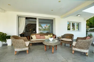 a patio with chairs and a couch and a table at Villa Emilia in Ayia Napa