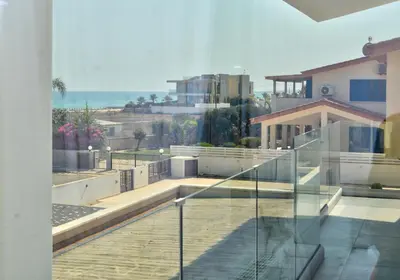 a balcony of a house with a view of the ocean at Villa Emilia in Ayia Napa
