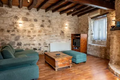 a living room with a couch and a table at Casa Piedra, Hidden Gem, Jacuzzi, BBQ, Patio in Monagroulli in Monagrulli