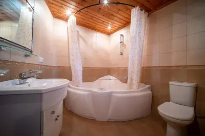 a bathroom with a tub and a toilet and a sink at Casa Piedra, Hidden Gem, Jacuzzi, BBQ, Patio in Monagroulli in Monagrulli