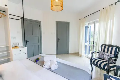a bedroom with a bed and a chair and a window at Zalihe Boutique Hotel North Nicosia in Nicosia
