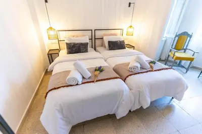 two beds in a room with white sheets and towels at Zalihe Boutique Hotel North Nicosia in Nicosia