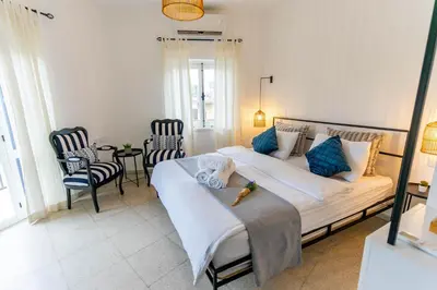 a bedroom with a large bed with blue pillows at Zalihe Boutique Hotel North Nicosia in Nicosia