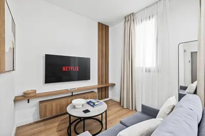 a living room with a couch and a tv at Artemis 104 - Seaside Stories in Livadhia