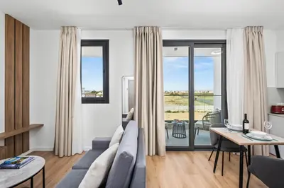 a living room with a couch and a table at Artemis 104 - Seaside Stories in Livadhia