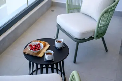 a table with a bowl of fruit and two cups of coffee at Artemis 104 - Seaside Stories in Livadhia