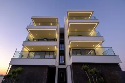a tall white building with balconies on it at Artemis 104 - Seaside Stories in Livadhia