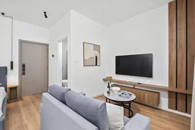 a living room with a couch and a tv at Artemis 104 - Seaside Stories in Livadhia
