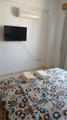 a bedroom with a bed with a flowered bedspread at Unique City room in Larnaka