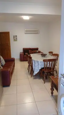 a living room with a table and chairs and a couch at Unique City room in Larnaka