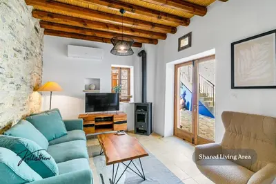 a living room with a blue couch and a table at Kallistheni - Stylish Studio Apartments in Lefkara in Pano Lefkara