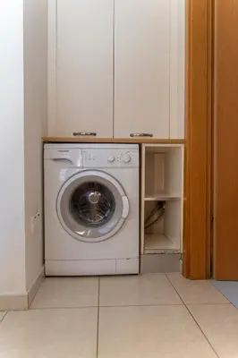 a washer and dryer sitting in a laundry room at Modern 1 bedroom flat in Strovolos