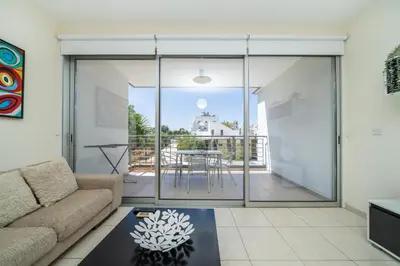 a living room with a couch and a table at Modern 1 bedroom flat in Strovolos