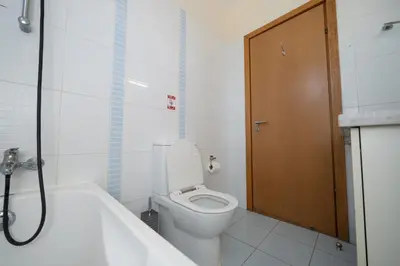a bathroom with a toilet and a bath tub at Modern 1 bedroom flat in Strovolos