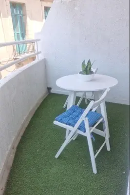 a white table and a chair on a balcony at Domus ArsEleAndra Studio-162 in Larnaka