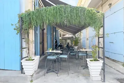 a pergola with tables and chairs and plants at Domus ArsEleAndra Studio-162 in Larnaka