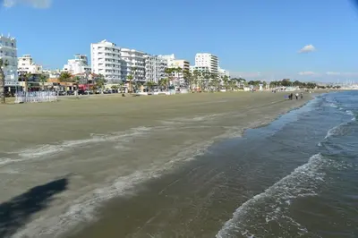 a view of a beach with buildings in the background at Domus ArsEleAndra Studio-162 in Larnaka
