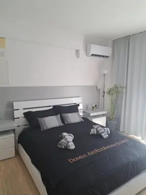 a bedroom with a large bed with shoes on it at Domus ArsEleAndra Studio-162 in Larnaka