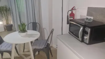 a small kitchen with a table and a microwave at Domus ArsEleAndra Studio-162 in Larnaka