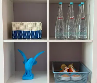 a shelf with bottles and a basket of shoes at Zima Cove Calm Coastal Oasis in Limassol