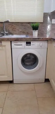 a washing machine in a kitchen with a sink at Villa Rossa in Pissouri