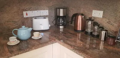 a counter top with a coffee maker and appliances on it at Villa Rossa in Pissouri