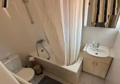 a bathroom with a tub and a toilet and a sink at Villa Rossa in Pissouri