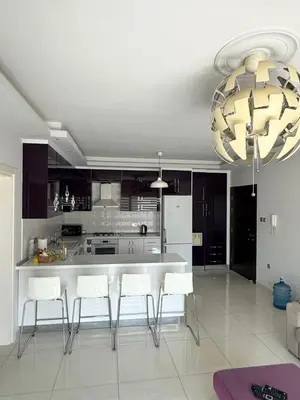 a kitchen with a table and some white chairs at Nicosia's Diamond in Nicosia