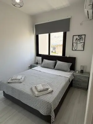 a bedroom with a large bed with two towels on it at Yenikent's Diamond in Nicosia