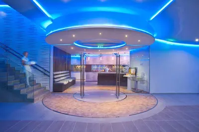 a lobby with a blue ceiling and a staircase at Pernera Beach Hotel in Protaras