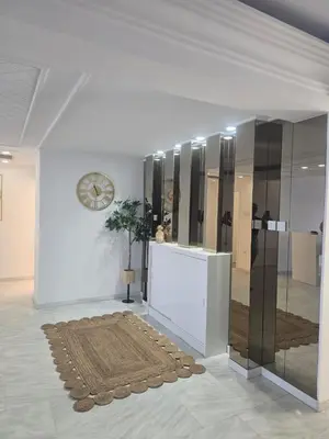 a room with a clock on the wall and a rug at Lazuli Skyline & Sea View Penthouse in Larnaka