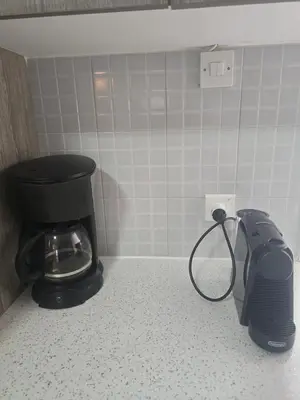 a bathroom with a toilet and a toaster on a counter at Lazuli Skyline & Sea View Penthouse in Larnaka