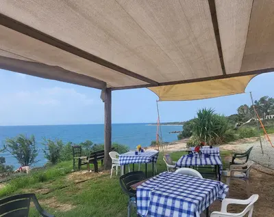a group of tables with a view of the ocean at Domes at the Beach in Maroni
