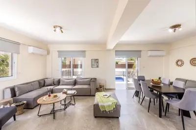 a living room with a couch and a table at Villa Chrystalla in Paralimni