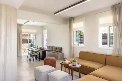 a living room with a couch and a table at Villa Mesogeios 4 in Protaras