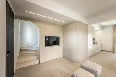 a living room with a tv and a chair at Villa Mesogeios 4 in Protaras