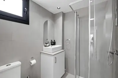 a bathroom with a shower and a toilet and a sink at Finikoudes Marina View #201 in Larnaka