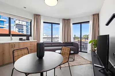 a living room with a couch and a table at Finikoudes Marina View #201 in Larnaka