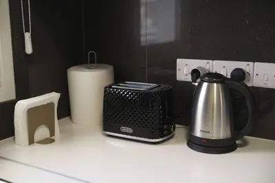 a kitchen counter with a toaster and a tea kettle at Central 2 bdr Flat St Lazaros - Phoenix Lodge in Larnaka