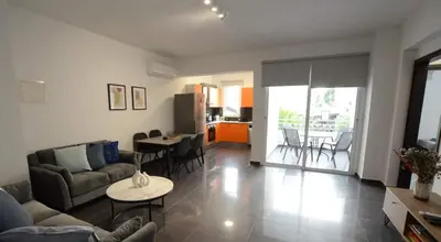 a living room with a couch and a table at Central 2 bdr Flat St Lazaros - Phoenix Lodge in Larnaka
