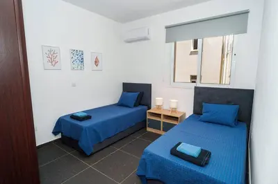a room with two beds and a window at Central 2 bdr Flat St Lazaros - Phoenix Lodge in Larnaka