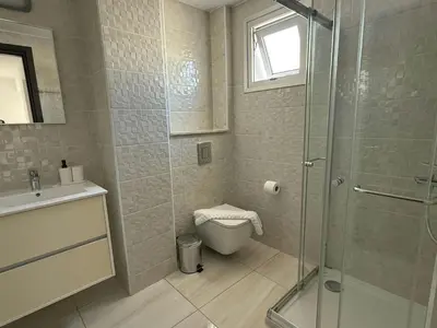 a bathroom with a shower and a toilet and a sink at TooCoool Villa - Elite Sea Breeze in Ayia Napa