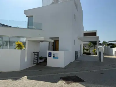 a white building with a staircase in front of it at TooCoool Villa - Elite Sea Breeze in Ayia Napa