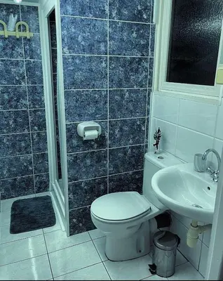 a bathroom with a toilet and a sink at Comfortable Vacation House in Protaras